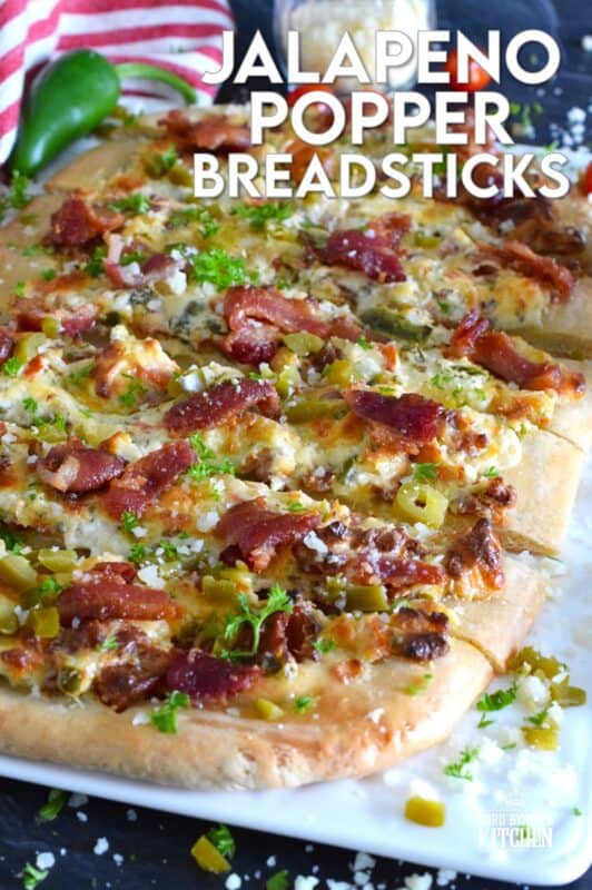 Dripping with melted cheese, Jalapeno Popper Breadsticks are prepared with pickled jalapenos, crumbled bacon, and cream cheese! Make this appetizer in less than 30 minutes and watch as everyone gobbles them up! Pair these with your favourite ranch dressing or, my personal favourite, a sweet, homemade dipping sauce to balance the spiciness of the jalapenos! #jalapeno #popper #breadsticks #appetizer