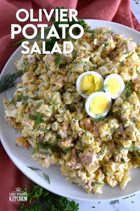 This salad might be more popular in Europe, but there is no reason why anyone shouldn't get to enjoy this creamy, delicous salad.  Olivier Potato Salad is very hearty; prepared with eggs, ham, carrots, and pickles, this salad is full of robust flavour! Serve as a side, or even as a course if preparing for a fancy dinner! #olivier #olivye #potato #salad #ham #russian