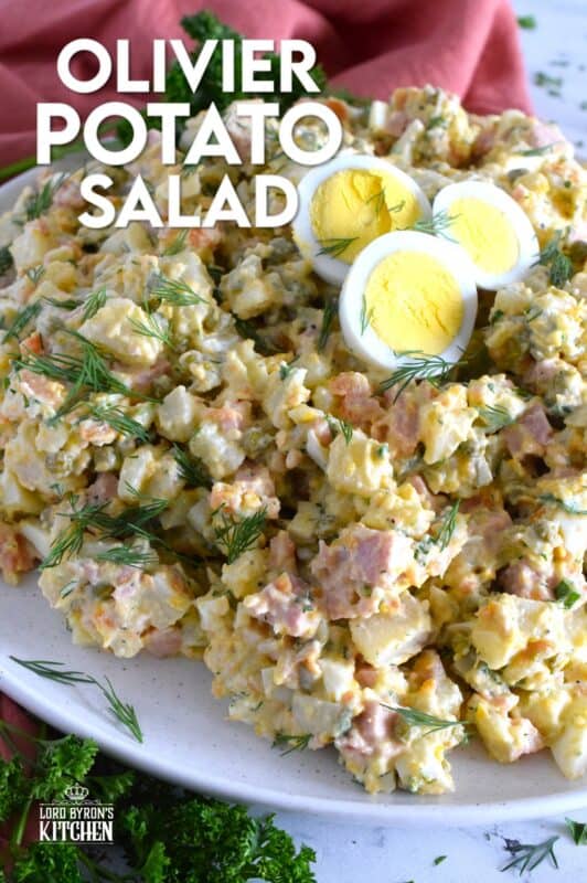 This salad might be more popular in Europe, but there is no reason why anyone shouldn't get to enjoy this creamy, delicous salad.  Olivier Potato Salad is very hearty; prepared with eggs, ham, carrots, and pickles, this salad is full of robust flavour! Serve as a side, or even as a course if preparing for a fancy dinner! #olivier #olivye #potato #salad #ham #russian