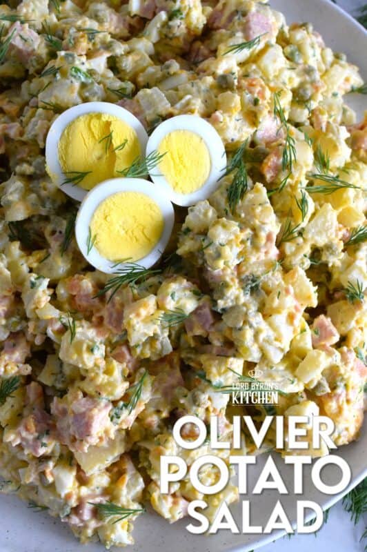 This salad might be more popular in Europe, but there is no reason why anyone shouldn't get to enjoy this creamy, delicous salad.  Olivier Potato Salad is very hearty; prepared with eggs, ham, carrots, and pickles, this salad is full of robust flavour! Serve as a side, or even as a course if preparing for a fancy dinner! #olivier #olivye #potato #salad #ham #russian