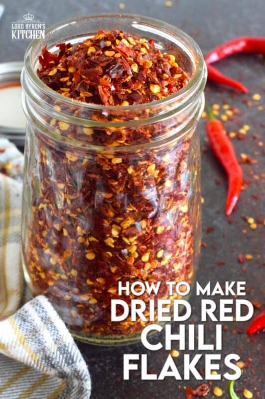 Every summer I harvest an abundance of cayenne peppers from my garden - way too many to eat fresh, so I dry them! Let me tell you how to make dried red chili flakes the easy way - no special equipment needed here; just a baking tray and a warm oven! #cayenne #driedredchili #chiliflakes #chillies #dried #preserve