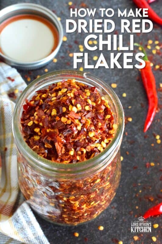 Every summer I harvest an abundance of cayenne peppers from my garden - way too many to eat fresh, so I dry them! Let me tell you how to make dried red chili flakes the easy way - no special equipment needed here; just a baking tray and a warm oven! #cayenne #driedredchili #chiliflakes #chillies #dried #preserve