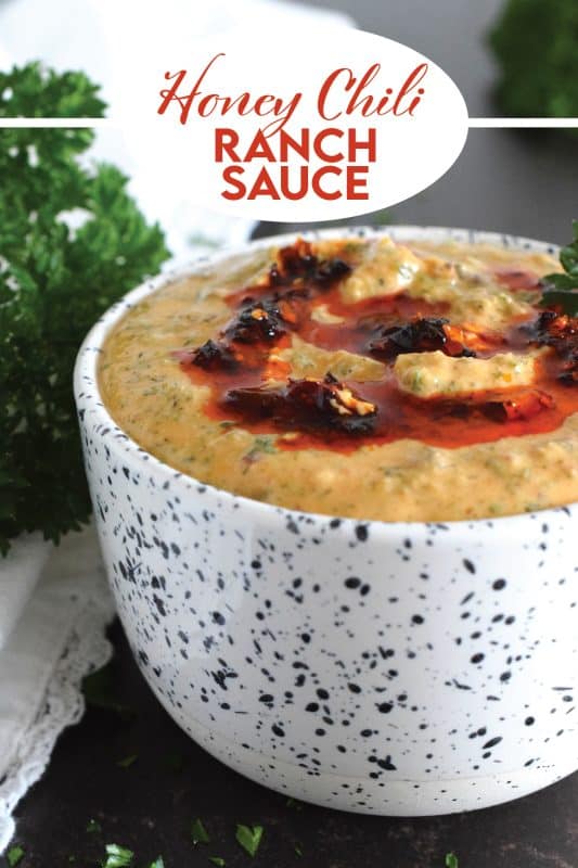 This sauce has it all! First of all, it's quite delicious; it's got heat from some chili crisp oil, coolness from the sour cream, sweetness from a bit of honey, and loads of savoury flavour from an abundance of dried herbs.  Honey Chili Ranch Sauce is great as a dip or a spread! #honey #chili #crisp #oil #sauce