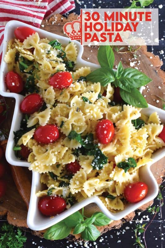 The combination of bright red cherry tomatoes and the forest green colour of sauteed kale come together to make this 30 Minute Holiday Pasta! Perfectly cooked pasta is tossed in a salted butter and garlic sauce with aromatic herbs - simple and delicious! #pasta #holiday #redandgreen #kale #tomatoes