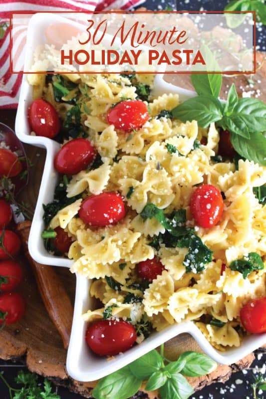 The combination of bright red cherry tomatoes and the forest green colour of sauteed kale come together to make this 30 Minute Holiday Pasta! Perfectly cooked pasta is tossed in a salted butter and garlic sauce with aromatic herbs - simple and delicious! #pasta #holiday #redandgreen #kale #tomatoes