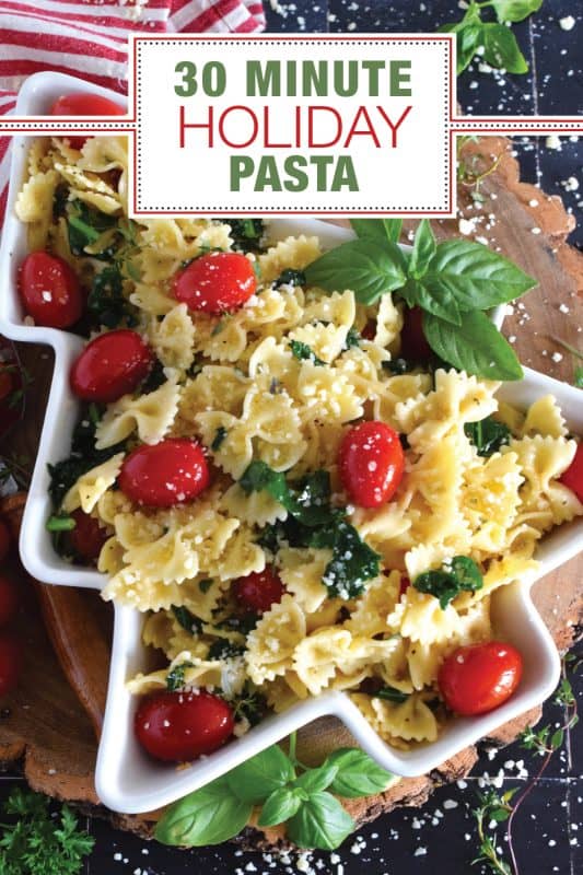 The combination of bright red cherry tomatoes and the forest green colour of sauteed kale come together to make this 30 Minute Holiday Pasta! Perfectly cooked pasta is tossed in a salted butter and garlic sauce with aromatic herbs - simple and delicious! #pasta #holiday #redandgreen #kale #tomatoes