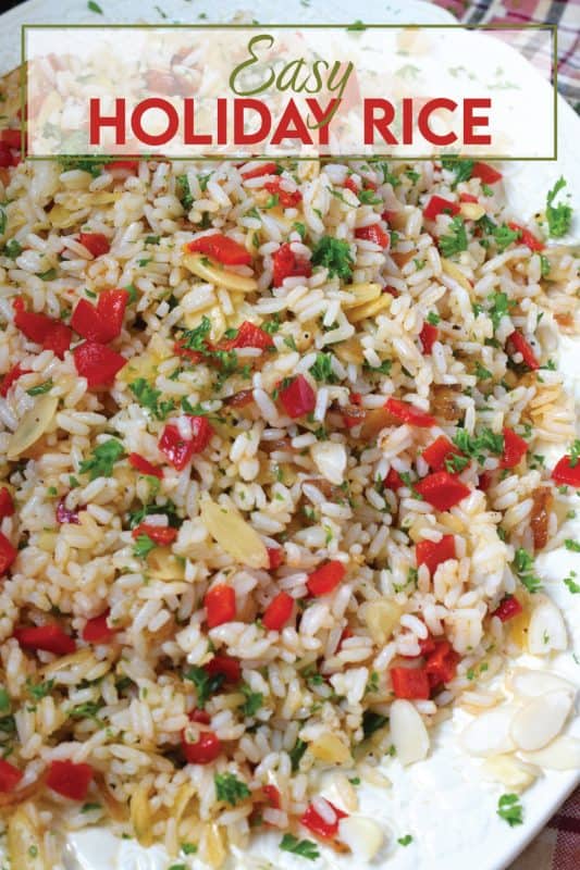Transform inexpensive plain white rice into the most delicious holiday side dish! Prepared with fresh garlic and ginger, this rice is certainly aromatic.  Tossed with caramelized onions, roasted red peppers, and blanched almonds, Easy Holiday Rice could just become a regular part of your holiday dinners! #rice #leftover #holiday #caramelized #onion #peppers #almonds