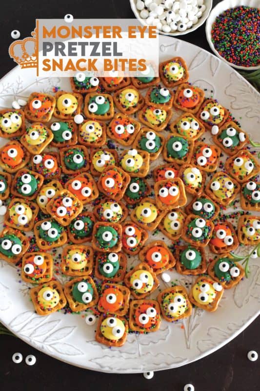 Usually, these types of snacks are prepared with a chocolate center, but to keep these Monster Eye Pretzel Snack Bites as halloween-like as possible, use a combination of yellow, green, and orange candy melt wafers instead! Top them with a candy eyes and halloween-themed sprinkles! Not only are they super cute, but they’re also super delicious! #monster #halloween #nobake #candy #pretzel #snack