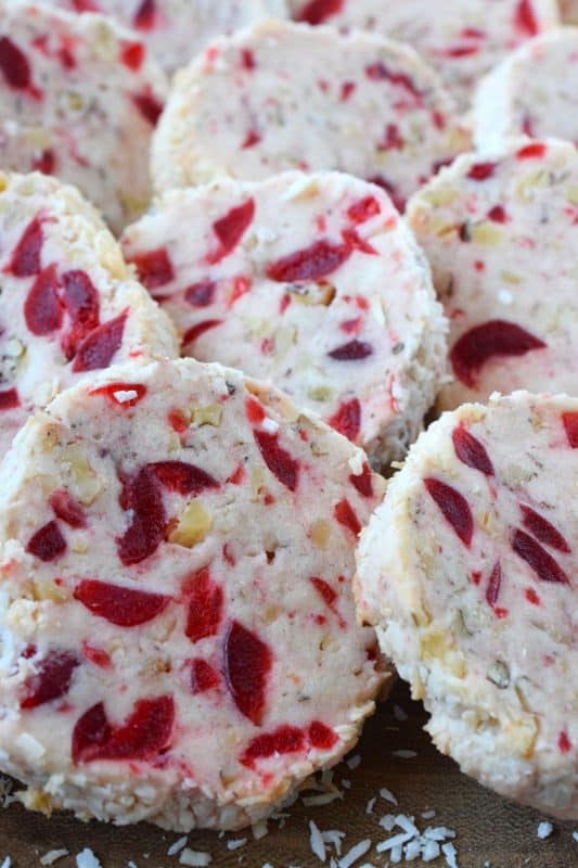 Chopped red candied cherries add a pop of festive colour and delicious flavour while the toasted walnuts and coconut add crunch and chewiness.  Santa's Whiskers can be prepared in advance and frozen.  To bake, just slice and pop them into the oven!  #candied #cherry #cherries #whiskers #santa #cookies #freezer #walnuts