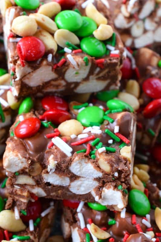 Homemade sweet treats can’t get any easier than a fudge recipe.  Holiday Rocky Road Squares combines traditional Rocky Road ingredients like chocolate, nuts, and marshmallows. Throw in some red and green M&Ms and a few sprinkles to make these festive treats! These are so delicious when served chilled right from the fridge! #fudge #squares #rockyroad #chocolate