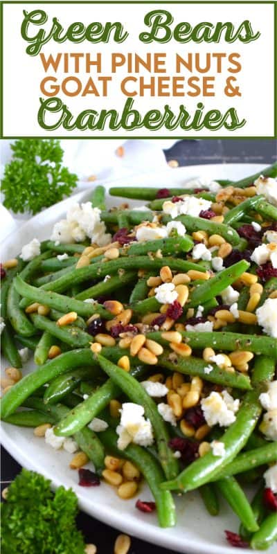 This delicious side dish prepared with green beans, toasted pine nuts, crumbled goat cheese, and dried cranberries takes only fifteen minutes in a skillet on your stovetop! How's that for a quick and easy holiday side?  Perfectly seasoned and quickly sauteed in butter, these green beans are delectably savoury! #greenbeans #cheese #pinenuts #thanksgiving #side