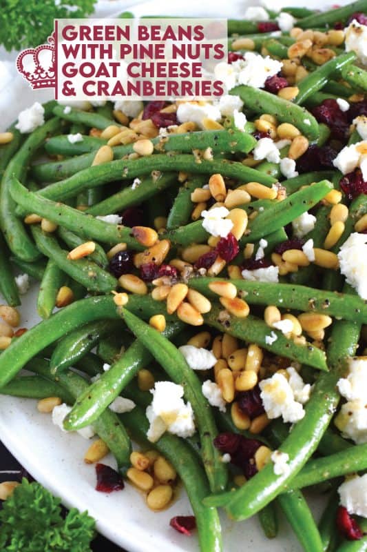 This delicious side dish prepared with green beans, toasted pine nuts, crumbled goat cheese, and dried cranberries takes only fifteen minutes in a skillet on your stovetop! How's that for a quick and easy holiday side?  Perfectly seasoned and quickly sauteed in butter, these green beans are delectably savoury! #greenbeans #cheese #pinenuts #thanksgiving #side