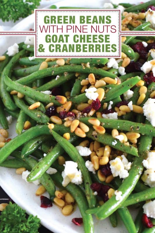 This delicious side dish prepared with green beans, toasted pine nuts, crumbled goat cheese, and dried cranberries takes only fifteen minutes in a skillet on your stovetop! How's that for a quick and easy holiday side?  Perfectly seasoned and quickly sauteed in butter, these green beans are delectably savoury! #greenbeans #cheese #pinenuts #thanksgiving #side