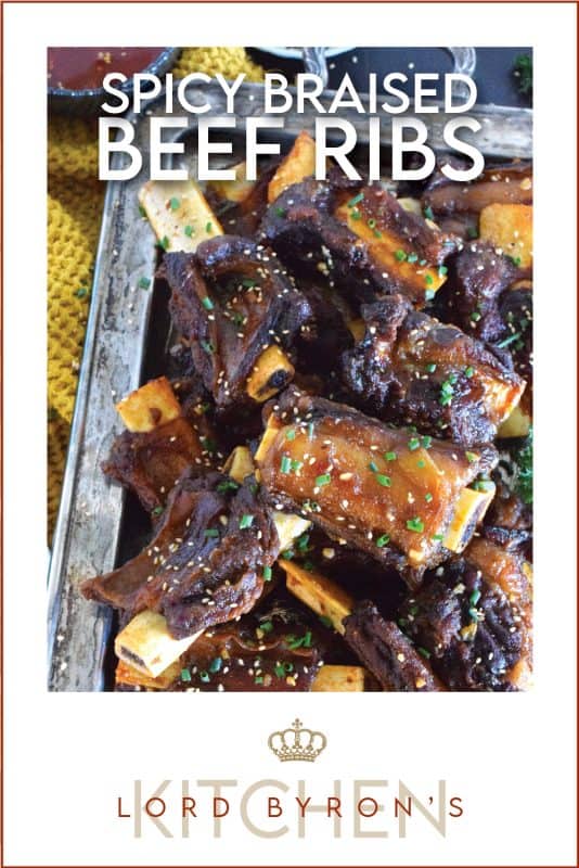 Beef ribs are braised in a sweet and sticky sauce prepared with red pepper paste and chilies. These moist and tender ribs are perfect for a cold winter night’s dinner!  Using easy to find Asian ingredients, these Spicy Braised Beef Ribs are easy to prepare and are simmered until the meat is practically falling off the bone! #beef #beefribs #spicy #braised