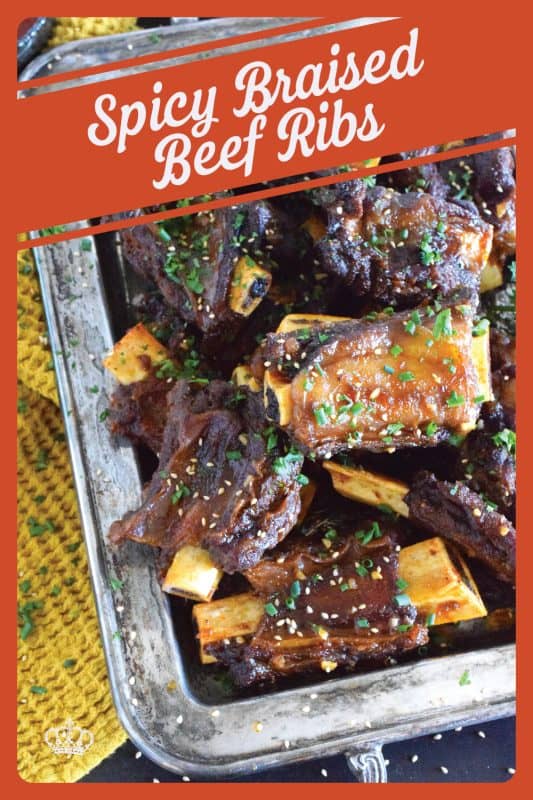 Beef ribs are braised in a sweet and sticky sauce prepared with red pepper paste and chilies. These moist and tender ribs are perfect for a cold winter night’s dinner!  Using easy to find Asian ingredients, these Spicy Braised Beef Ribs are easy to prepare and are simmered until the meat is practically falling off the bone! #beef #beefribs #spicy #braised