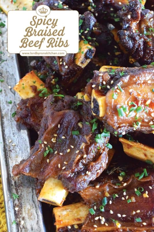 Beef ribs are braised in a sweet and sticky sauce prepared with red pepper paste and chilies. These moist and tender ribs are perfect for a cold winter night’s dinner!  Using easy to find Asian ingredients, these Spicy Braised Beef Ribs are easy to prepare and are simmered until the meat is practically falling off the bone! #beef #beefribs #spicy #braised