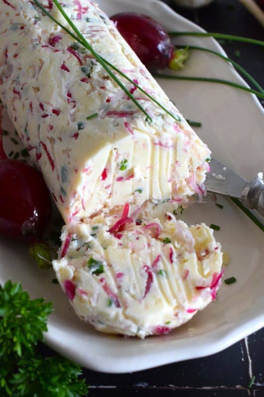 Liberally smear this Radish and Chive Butter onto lightly toasted bread or freshly baked scones.  Prepared with fresh ingredients and salted butter, it is an easy to make condiment that is quite delicious!  Place a small bowl of it on your next charcuterie board too! #radish #chive #butter #radishes