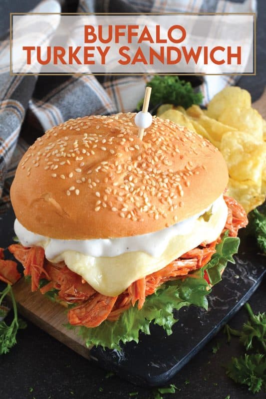 Leftover turkey never tasted so good! Shredded leftover turkey is tossed in a buffalo sauce and piled high onto your favourite sandwich bread or bun.  Topped with melted cheese and dill pickles, this Buffalo Turkey Sandwich is simple, quick, and easy, yet it tastes absolutely incredible!  #buffalo #turkey #leftover #sandwich