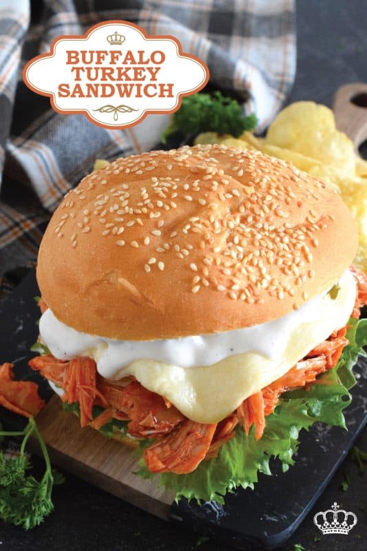 Leftover turkey never tasted so good! Shredded leftover turkey is tossed in a buffalo sauce and piled high onto your favourite sandwich bread or bun.  Topped with melted cheese and dill pickles, this Buffalo Turkey Sandwich is simple, quick, and easy, yet it tastes absolutely incredible!  #buffalo #turkey #leftover #sandwich