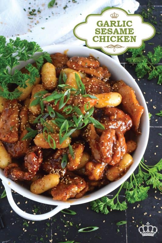 Dredged in a seasoned flour and pan-fried until golden brown, this chicken is tossed with a sweet and sticky garlic sesame sauce until thickened and glossy.  Optionally, add Korean rice cakes to make the dish stretch further or to make a heartier meal! #garlic #sesame #chicken #saucy #asian #ricecakes #tteok