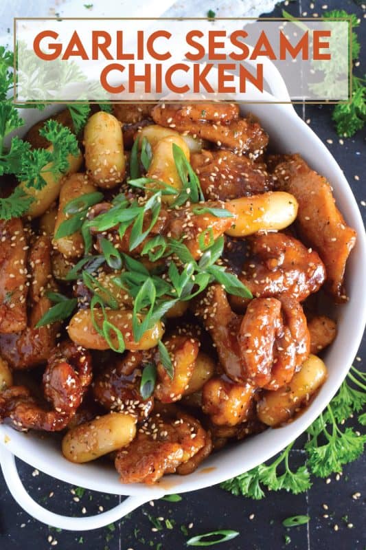 Dredged in a seasoned flour and pan-fried until golden brown, this chicken is tossed with a sweet and sticky garlic sesame sauce until thickened and glossy.  Optionally, add Korean rice cakes to make the dish stretch further or to make a heartier meal! #garlic #sesame #chicken #saucy #asian #ricecakes #tteok