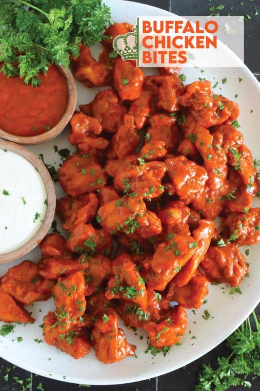 Dredged in a seasoned flour and fried until golden brown, Buffalo Chicken Bites are tossed with a quick and easy homemade buffalo sauce! Serve with your favourite ranch dipping sauce and veggies sticks. These are great as an appetizer for game day! #buffalo #buffalosauce #chicken #spicy #franks #bites #sauce