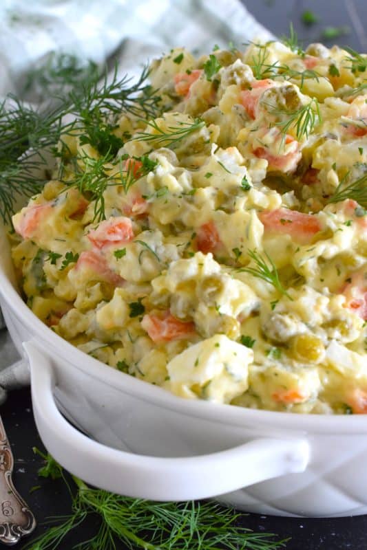 In our home, a potato salad will almost always have hard-boiled eggs and green onion in it, but in the case of this Polish Potato Salad, I'm adding finely chopped dill pickles, fresh dill, green peas, and minced white onions too! #potatosalad #salad #polish #dill
