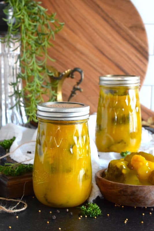 Sweet Mustard Pickles were often found on the table when I was growing up. They were store-bought and the brand was Bick's. This homemade copycat version is a near exact replica of the familiar jar of pickles my mom would serve alongside so many meals in our home. Prepared with cucumbers, cauliflower, and onions - just like the store-bought kind! - in a sweet and vinegary mustard sauce, these pickles are a Newfoundland favourite! #copycat #mustard #pickles #bicks #onions #cauliflower #homemade #canning
