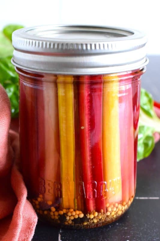Oftentimes, swiss chard stems are discarded, but did you know you can pickle them and they retain a crunchy texture with a tangy, sweet, and vinegary flavour? I'm using rainbow swiss chard here, but any chard will do. Try wrapping one with salty ham for a quick charcuterie-like snack! #swisschard #stems #pickled #quickpickle #refridgerator
