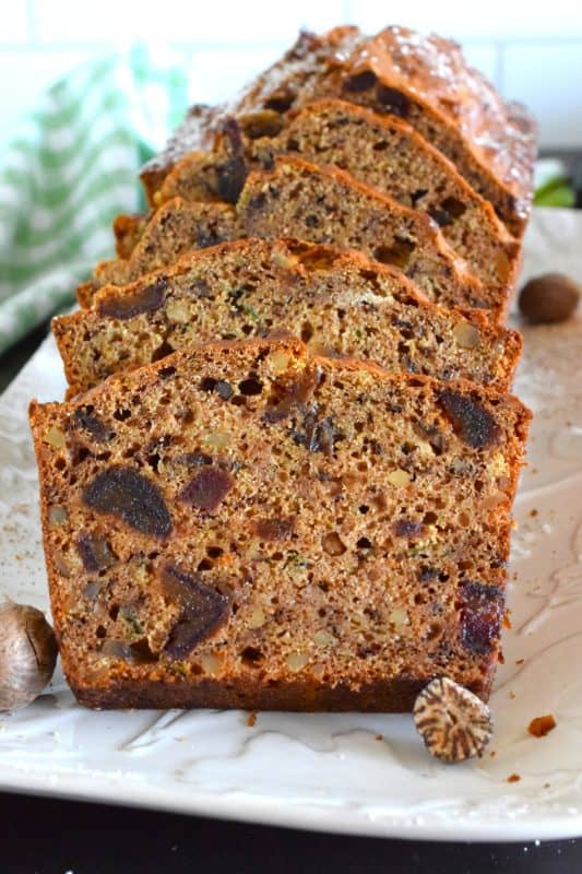 Best served with tea as an afternoon snack, this Zucchini Pumpkin Spice Walnut Loaf is very moist and packed with shredded zucchini, sweet chopped dates, and crunchy walnuts. Loaded with pumpkin spice seasoning blend, this loaf makes a great gift idea, and can be easily frozen for later too! #zucchini #loaf #bread #pumpkinspice #pumpkin