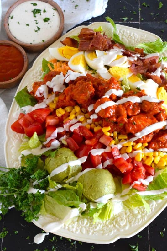 Some salads are light and leave you still hungry, and some salads, like this Buffalo Chicken Cobb Salad, are the complete opposite. Hearty, filling, delicious, and not even close to being just another boring salad, this one is a meal all on its own. Move over side salad; there’s no room for you at this table! #buffalo #chicken #cobb #cobbsalad #buffalochicken