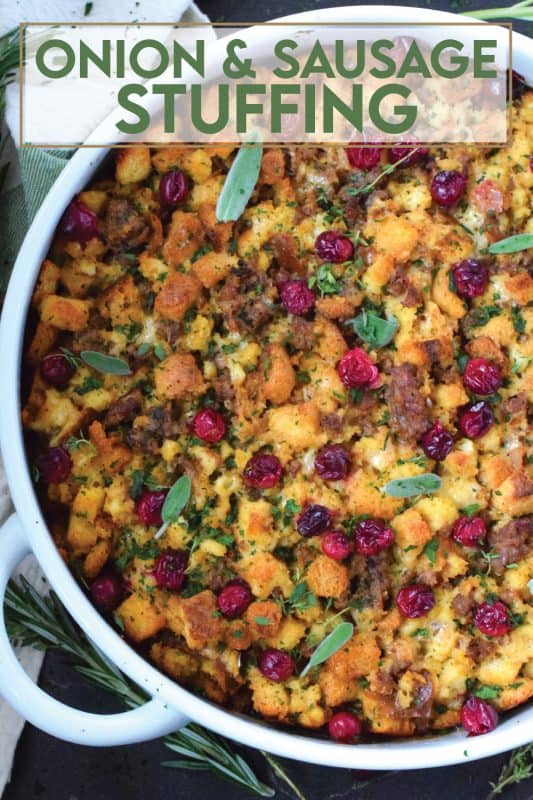 Stale bread cubes are combined with onion, butter, fresh herbs, fresh cranberries, and fried sausage meat. Moistened with stock, whisked eggs, and cheese, this Onion and Sausage Stuffing just might be the most favoured side dish! Bake it in a pan on its own or stuff the turkey with it – this stuffing is delicious both ways! #stuffing #sausage #pork #thanksgiving