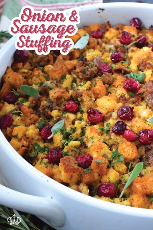Stale bread cubes are combined with onion, butter, fresh herbs, fresh cranberries, and fried sausage meat. Moistened with stock, whisked eggs, and cheese, this Onion and Sausage Stuffing just might be the most favoured side dish! Bake it in a pan on its own or stuff the turkey with it – this stuffing is delicious both ways! #stuffing #sausage #pork #thanksgiving