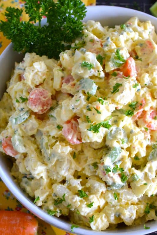 Ten years ago on a family road trip to Pennsylvannia, I tasted this Amish Potato Salad for the first time at a roadside barbecue restaurant.  It took me ten years to find that exact recipe! With a sweet, tangy, sour dressing, and it's distinctive yellow colour, this potato salad is absolute perfection! #amish #potatosalad #salad #amishsalad