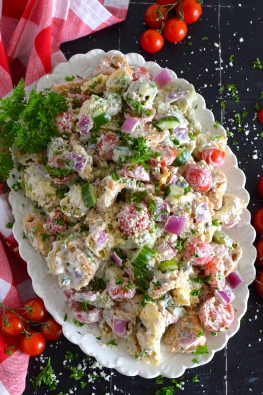 It's the combination of creamy mayonnaise with balsamic vinaigrette that makes this Italian-style pasta salad so delicious! Prepared with cheese-filled tortellini, cucumbers, tomatoes, red onions, celery, and parmesan, this salad is the perfect summer side! #pastasalad #pasta #balsamic #tortellini #side #summerside