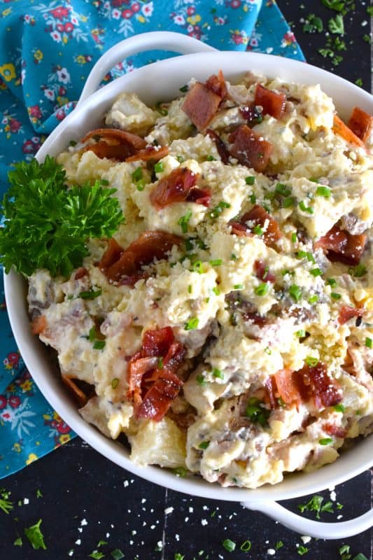 Forego the chopped lettuce and replace it with cubed baked potato to make the most delicious Caesar Potato Salad.  Loaded with bacon, hard-boiled eggs, fresh chives, and parmesan cheese, this salad is tossed with a caesar and mayo dressing.  #caesar #salad #potato #potatosalad #bakedpotato