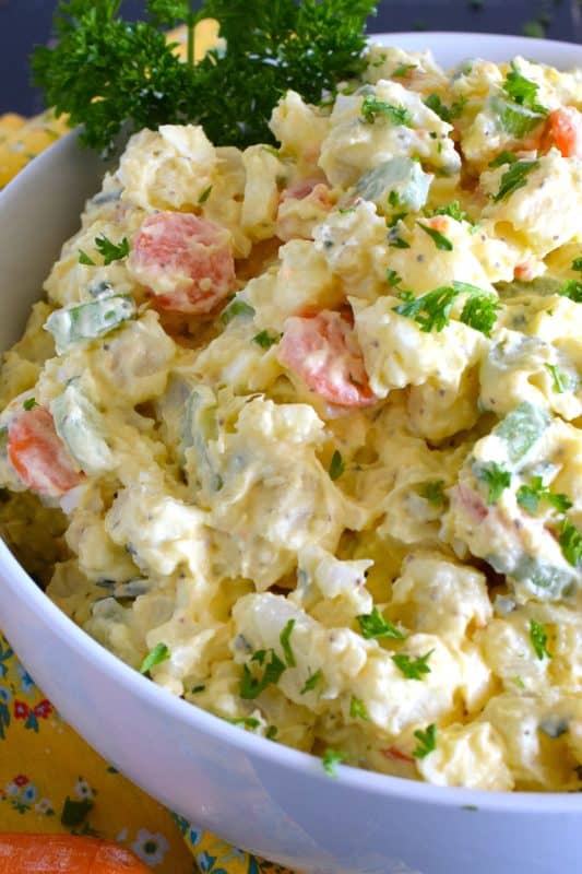 Ten years ago on a family road trip to Pennsylvannia, I tasted this Amish Potato Salad for the first time at a roadside barbecue restaurant.  It took me ten years to find that exact recipe! With a sweet, tangy, sour dressing, and it's distinctive yellow colour, this potato salad is absolute perfection! #amish #potatosalad #salad #amishsalad