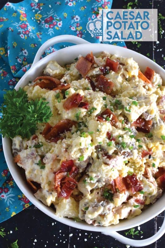 Forego the chopped lettuce and replace it with cubed baked potato to make the most delicious Caesar Potato Salad.  Loaded with bacon, hard-boiled eggs, fresh chives, and parmesan cheese, this salad is tossed with a caesar and mayo dressing.  #caesar #salad #potato #potatosalad #bakedpotato