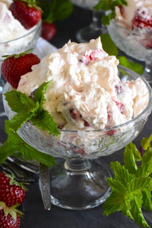 How would you like to prepare a delicious dessert in about ten minutes from start to finish? Strawberry Cheesecake Fluff will allow you to do just that! Prepared with cream cheese, cool whip, vanilla, and strawberries, this dessert is light and fluffy and perfectly refreshing for a warm summer day! #strawberry #cheesecake #nobake #dessert #strawberries #coolwhip #creamcheese