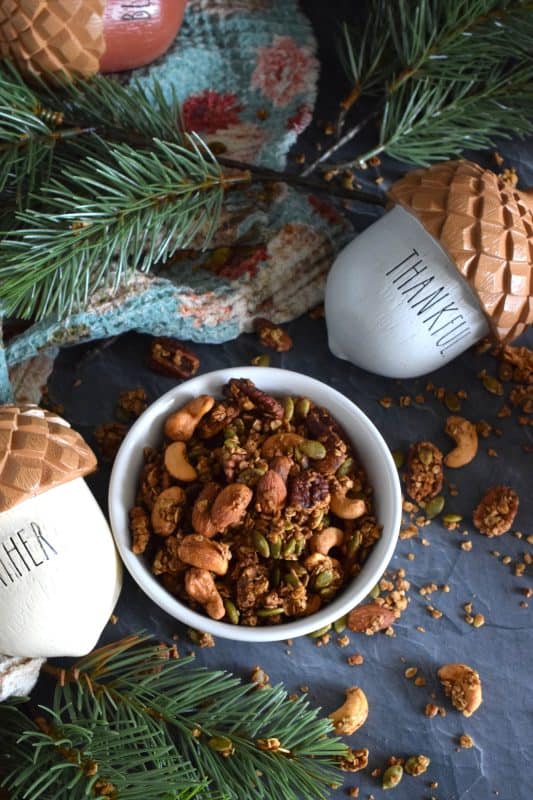 Prepared with both pumpkin puree and pumpkin spice, this Pumpkin Spice Granola is packed with good-for-you ingredients. Almonds, cashews, pecans, and pumpkin seeds help to flavour and bulk up this deliciously healthy snack. Baked with maple syrup and brown sugar, this granola makes a very delicious giftable treat too! #pumpkinspice #granola #pumpkin